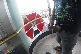 I jerk my cock very riskily in a public, transparent outdoor elevator on the 13th floor.